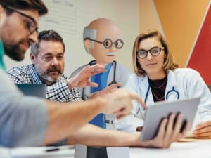 A picture of healthcare workers looking at a digital device.