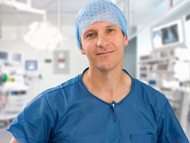 a picture of a male Clinician in a healthcare setting.